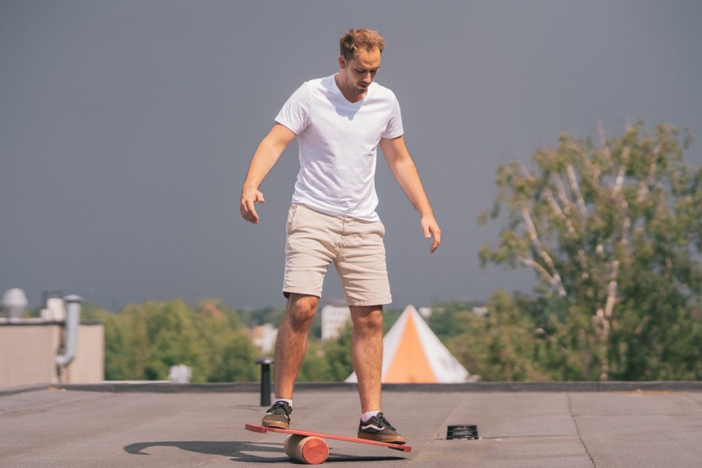 A man demonstrating the interplay of right vs left brain on a balance board